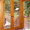 A view to the backyard from the back porch, outside of the dining room and kitchen